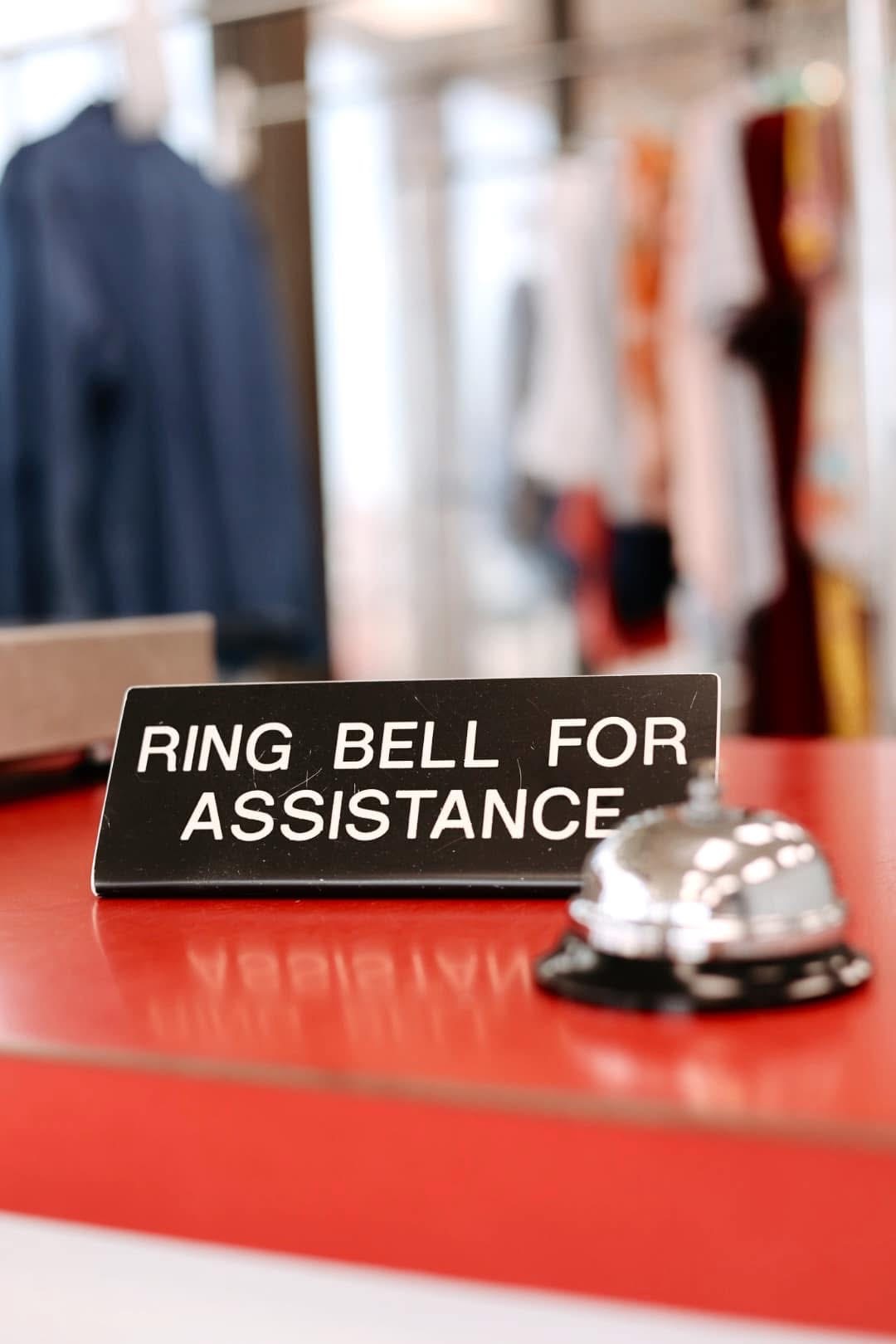 The friendly front counter at Laura's Laundromat with a Ring Bell for Assistance sign
